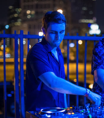 Starfell DJing on a rooftop at night